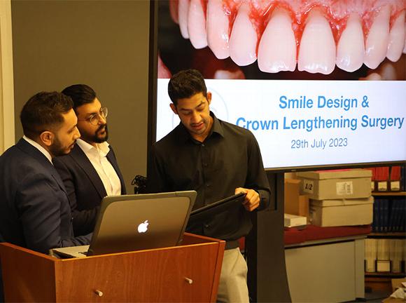 Speakers at podium of Smile Design lecture